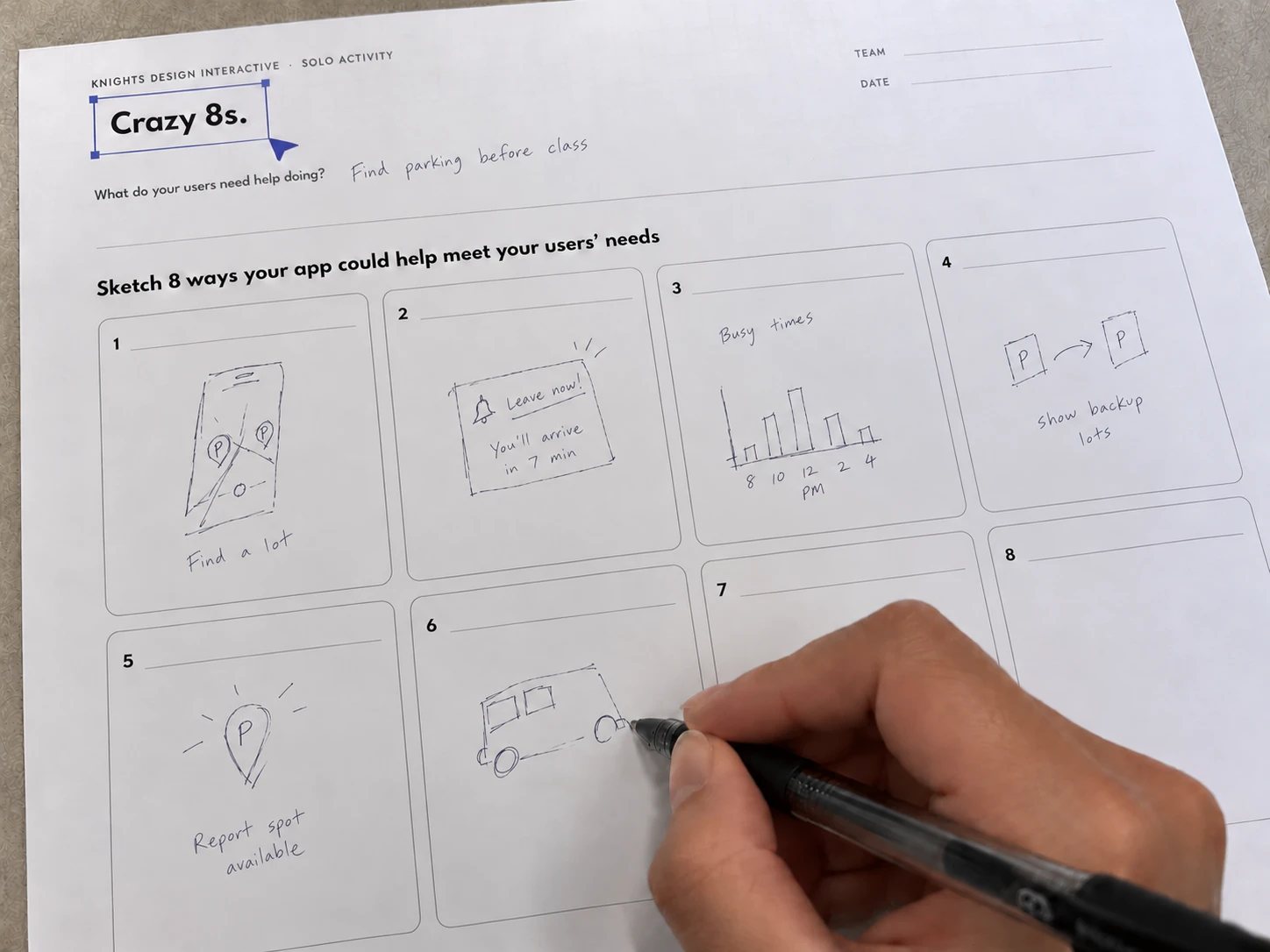 A filled-in Crazy 8s worksheet, pen in hand